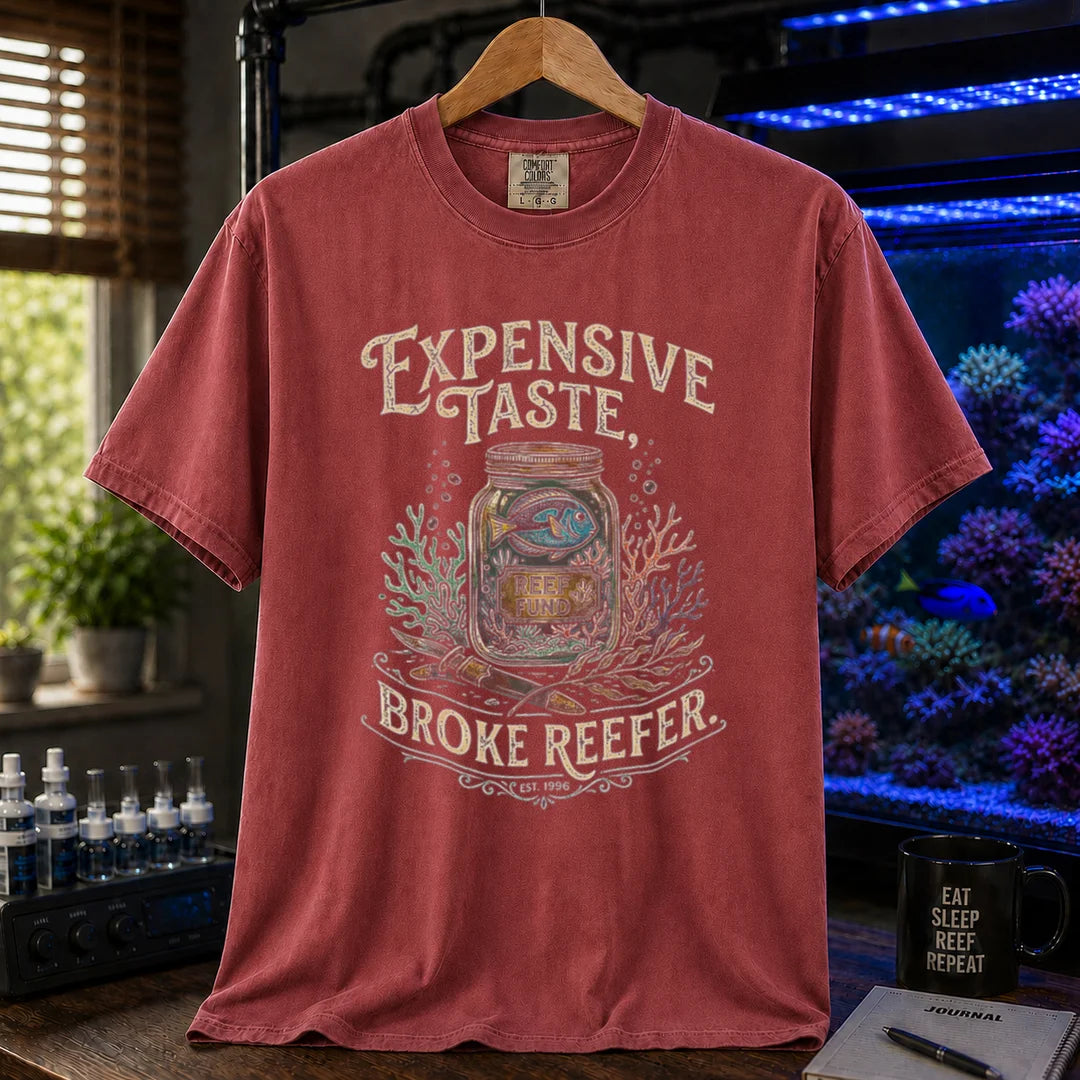 Saltwater aquarium graphic t-shirt featuring a reef fund jar illustration and text: EXPENSIVE TASTE, BROKE REEFER., maroon, red crew neck tee