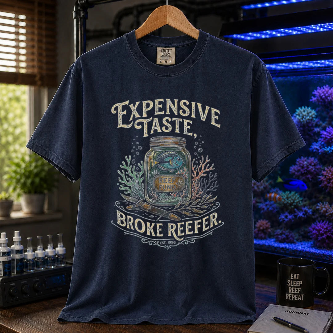 Saltwater aquarium graphic t-shirt featuring a reef fund jar illustration and text: EXPENSIVE TASTE, BROKE REEFER., navy crew neck tee