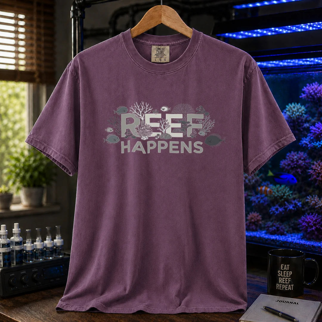 Saltwater aquarium graphic t-shirt featuring text reading REEF HAPPENS with embedded coral and fish illustrations, purple crew neck tee