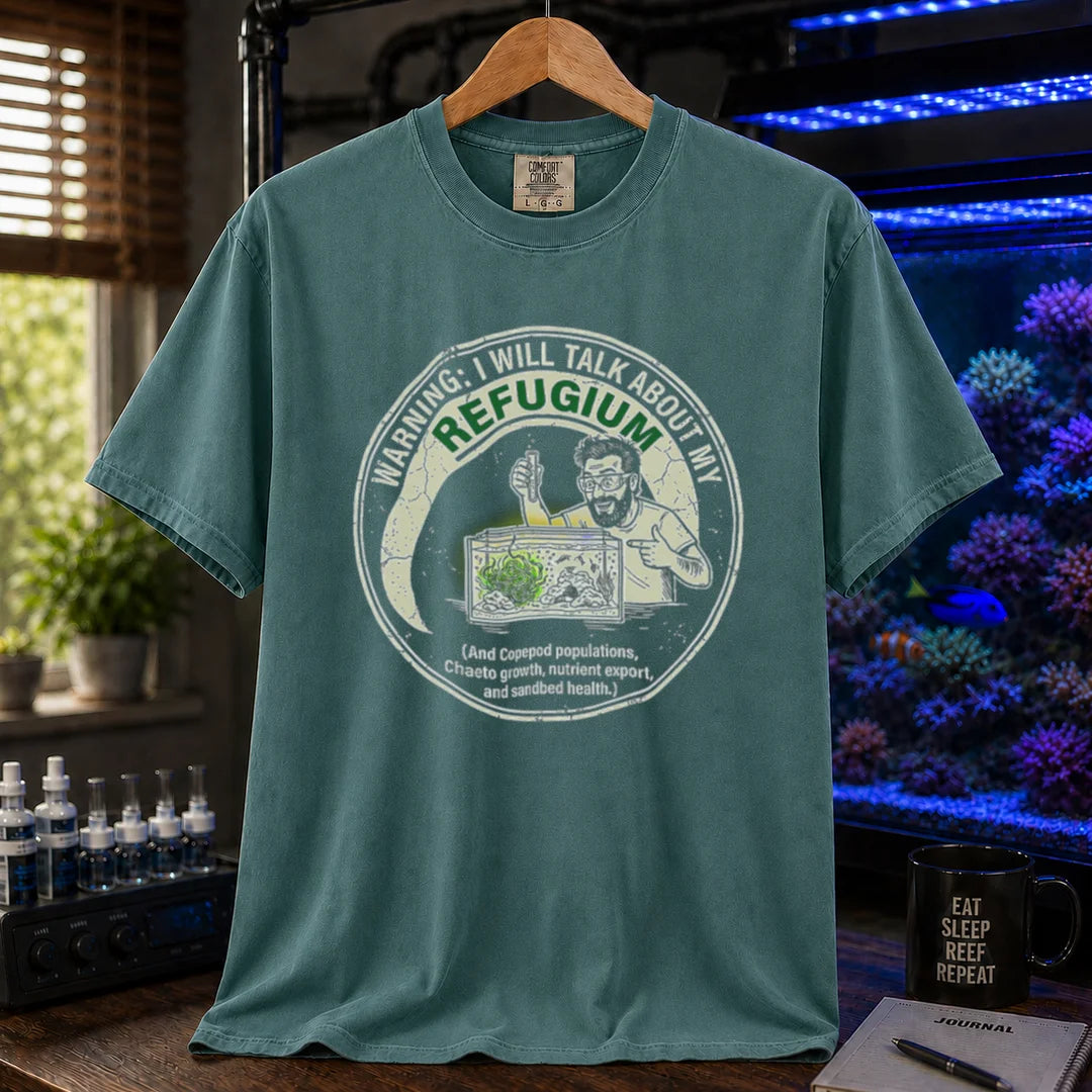 Saltwater aquarium graphic t-shirt featuring an illustration of an aquarist tending a refugium with text: WARNING: I WILL TALK ABOUT MY REFUGIUM (And Copepod populations, Chaeto growth, nutrient export, and sandbed health.), green crew neck tee