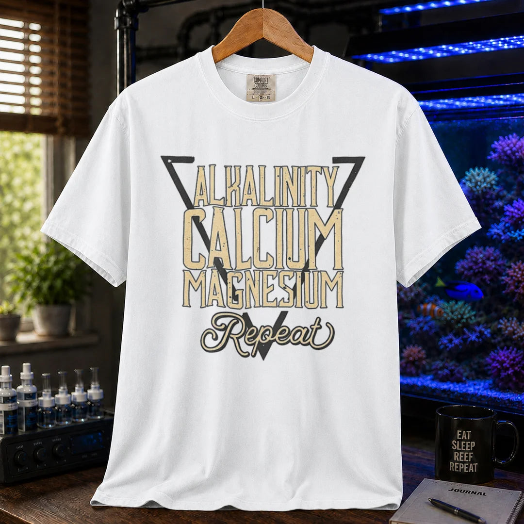 Saltwater aquarium graphic t-shirt featuring a triangle frame and text: ALKALINITY CALCIUM MAGNESIUM Repeat, white crew neck tee