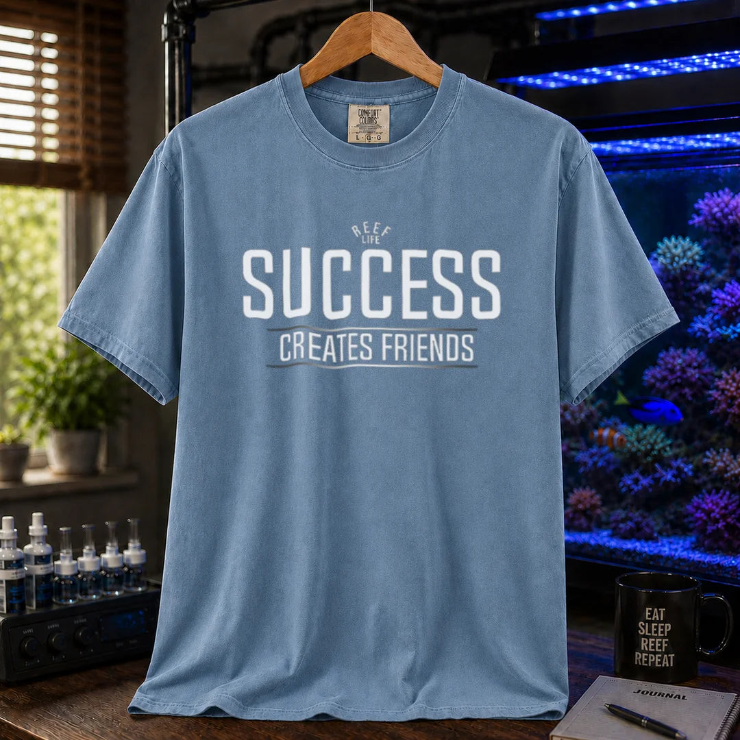 Saltwater aquarium graphic t-shirt featuring text: REEF LIFE SUCCESS CREATES FRIENDS, blue crew neck tee