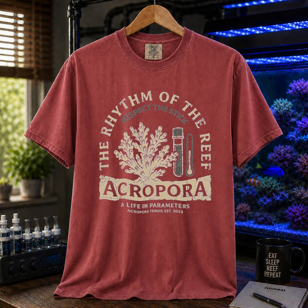 Saltwater aquarium graphic t-shirt featuring an Acropora coral and test kit illustration with text: THE RHYTHM OF THE REEF ACROPORA A LIFE IN PARAMETERS, maroon, red crew neck tee