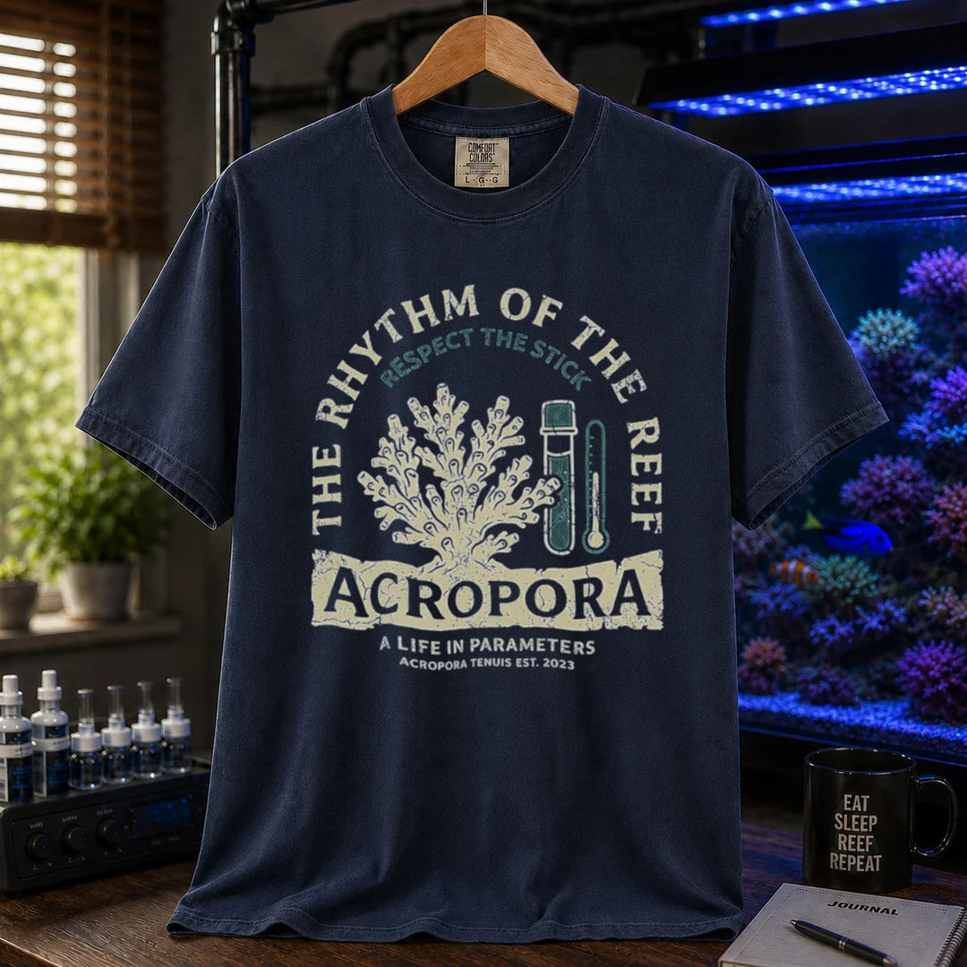 Saltwater aquarium graphic t-shirt featuring an Acropora coral and test kit illustration with text: THE RHYTHM OF THE REEF ACROPORA A LIFE IN PARAMETERS, navy crew neck tee