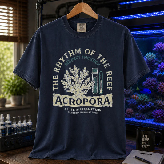 Saltwater aquarium graphic t-shirt featuring an Acropora coral and test kit illustration with text: THE RHYTHM OF THE REEF ACROPORA A LIFE IN PARAMETERS, navy crew neck tee