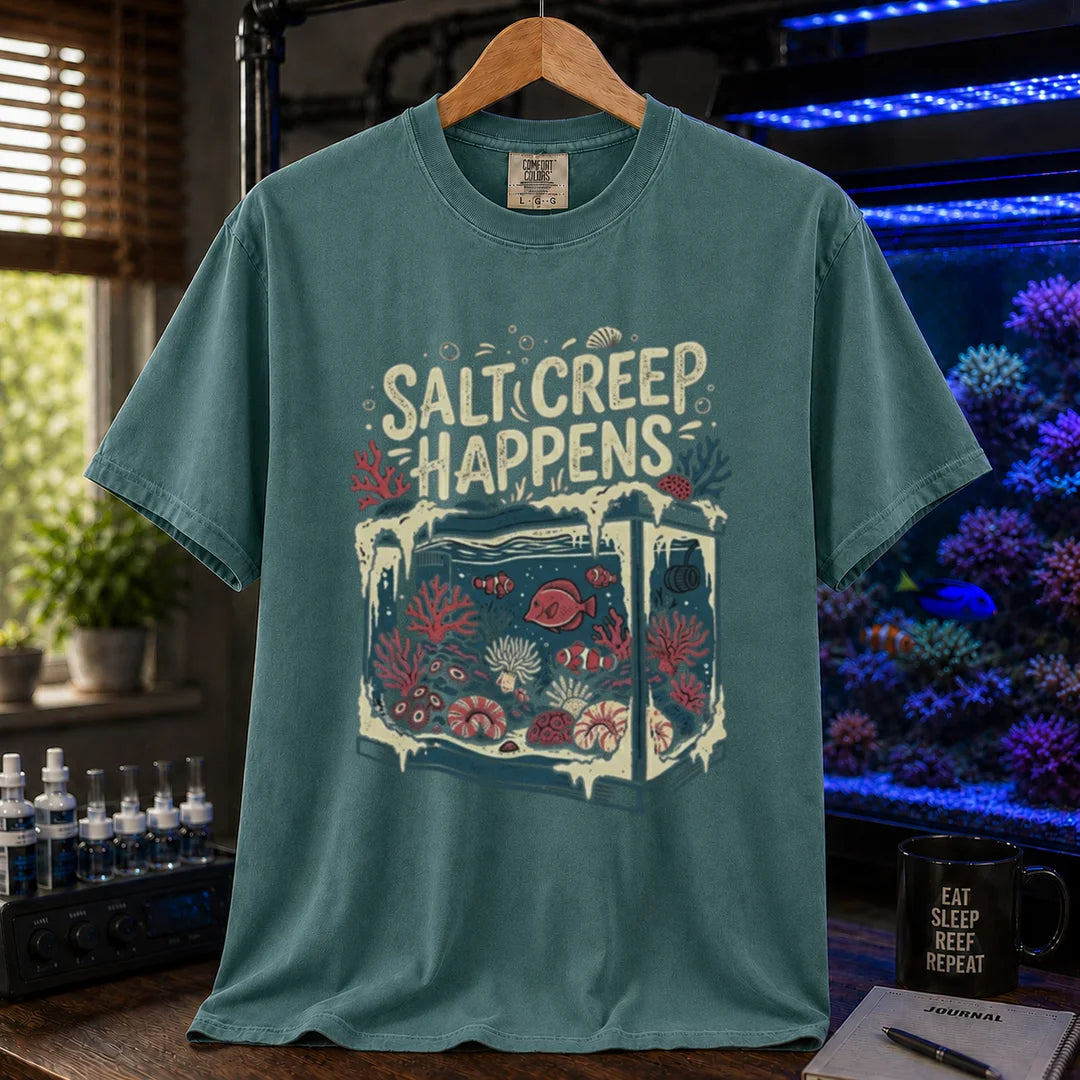 Saltwater aquarium graphic t-shirt featuring an illustration of a tank covered in salt buildup with text: SALT CREEP HAPPENS, green crew neck tee