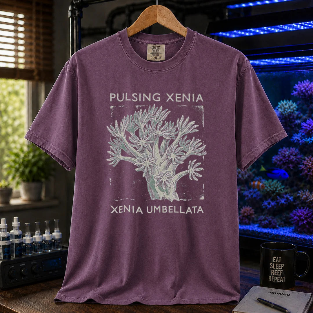 Saltwater aquarium graphic t-shirt featuring a Pulsing Xenia coral illustration with text: PULSING XENIA XENIA UMBELLATA, purple crew neck tee