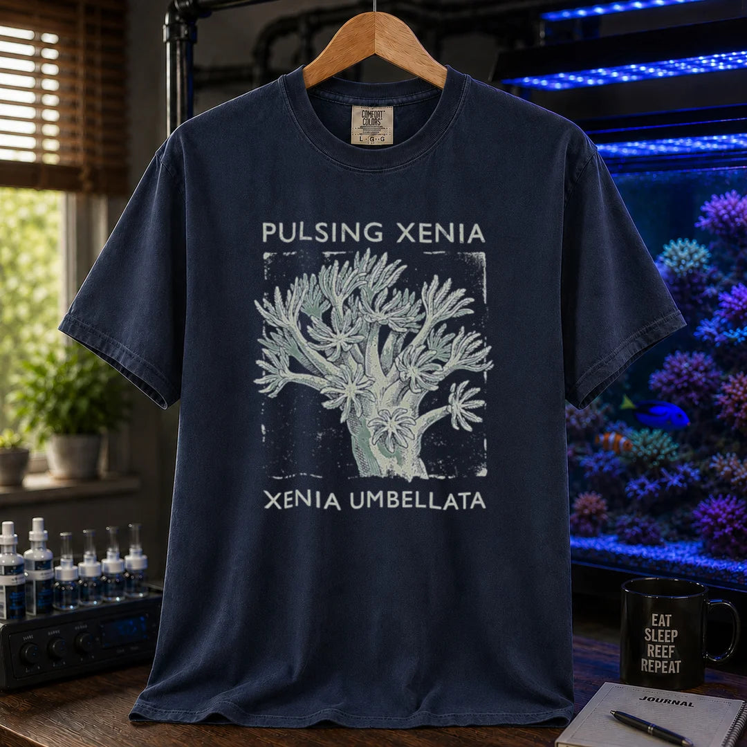 Saltwater aquarium graphic t-shirt featuring a Pulsing Xenia coral illustration with text: PULSING XENIA XENIA UMBELLATA, navy crew neck tee