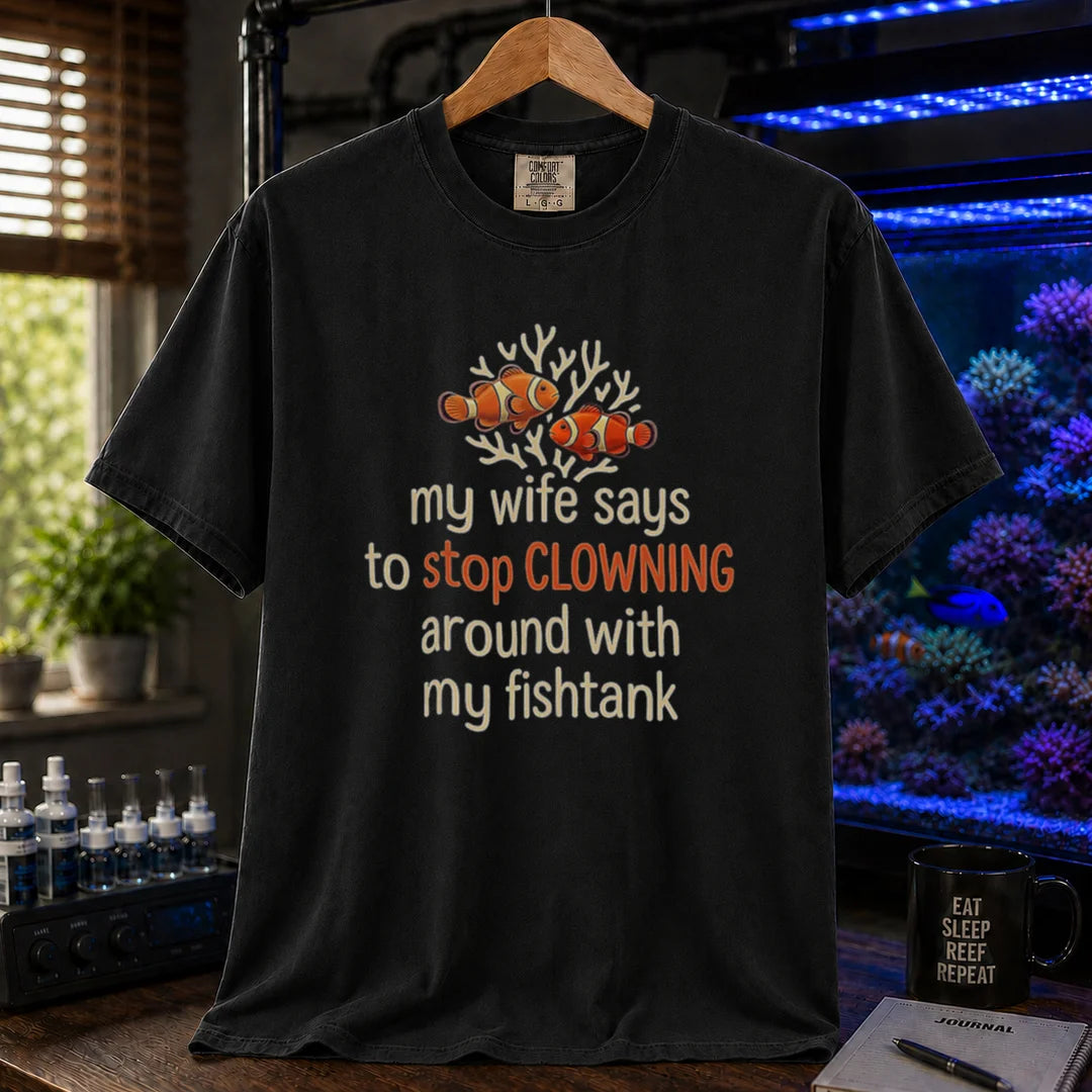 Saltwater aquarium graphic t-shirt featuring a clownfish illustration and text: my wife says to stop CLOWNING around with my fishtank, black crew neck tee