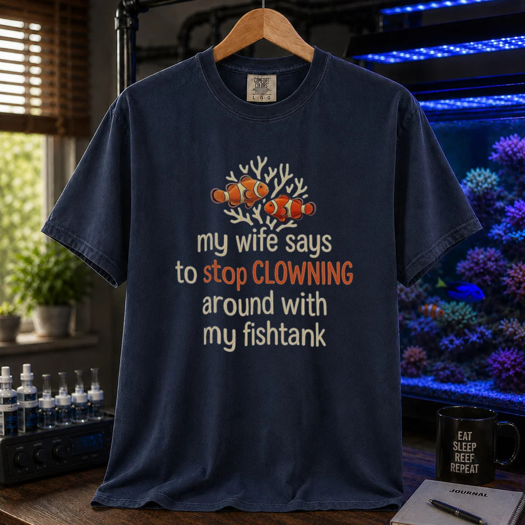 Saltwater aquarium graphic t-shirt featuring a clownfish illustration and text: my wife says to stop CLOWNING around with my fishtank, navy crew neck tee