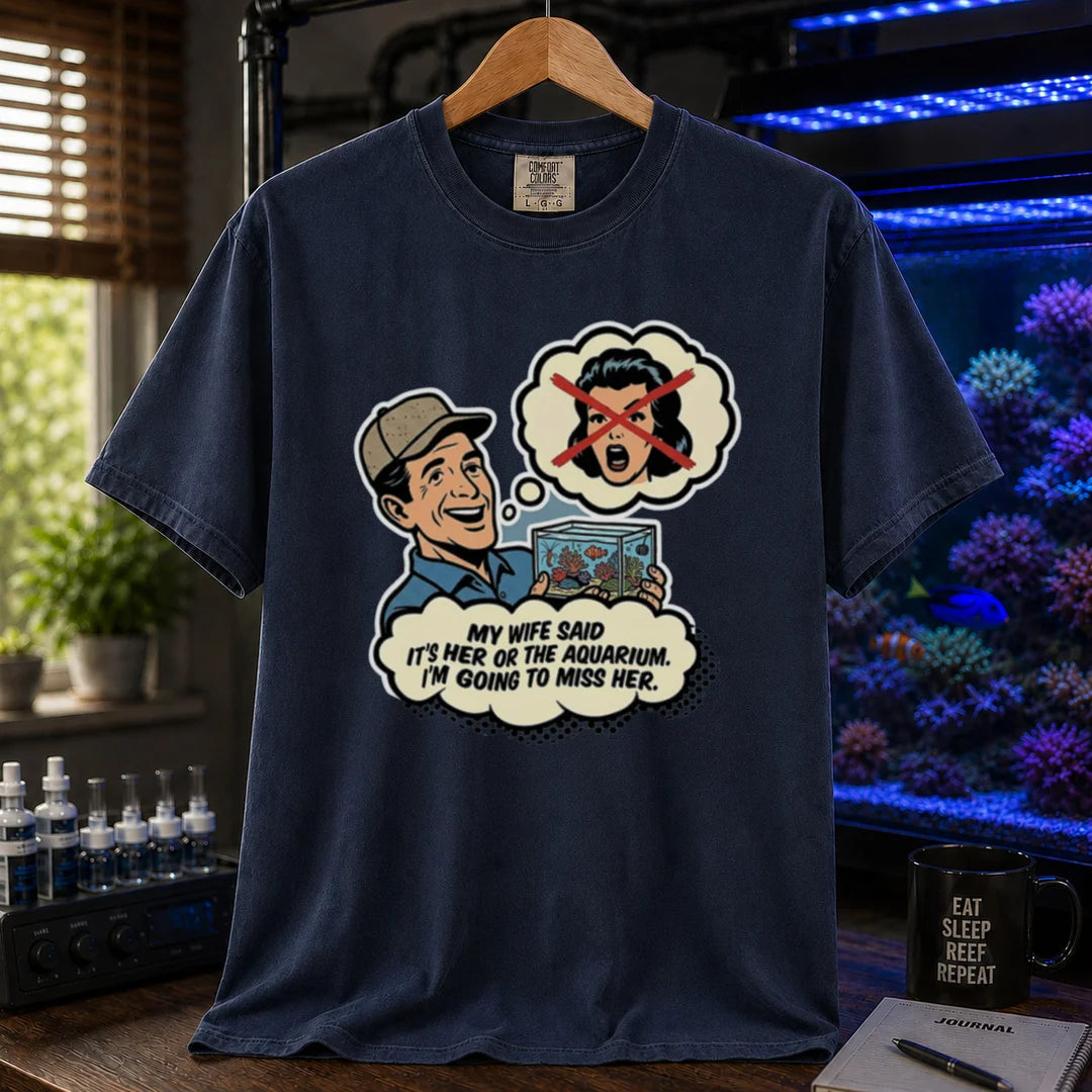Saltwater aquarium graphic t-shirt featuring a retro comic illustration and text: MY WIFE SAID IT'S HER OR THE AQUARIUM. I'M GOING TO MISS HER., navy crew neck tee