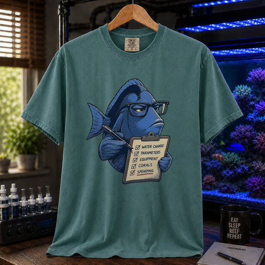 Saltwater aquarium graphic t-shirt featuring a blue tang with glasses holding a maintenance clipboard, green crew neck tee