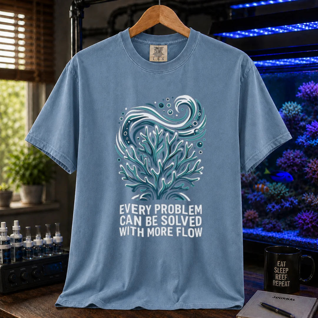 Saltwater aquarium graphic t-shirt featuring a swirling water current and coral illustration with text: EVERY PROBLEM CAN BE SOLVED WITH MORE FLOW, blue crew neck tee