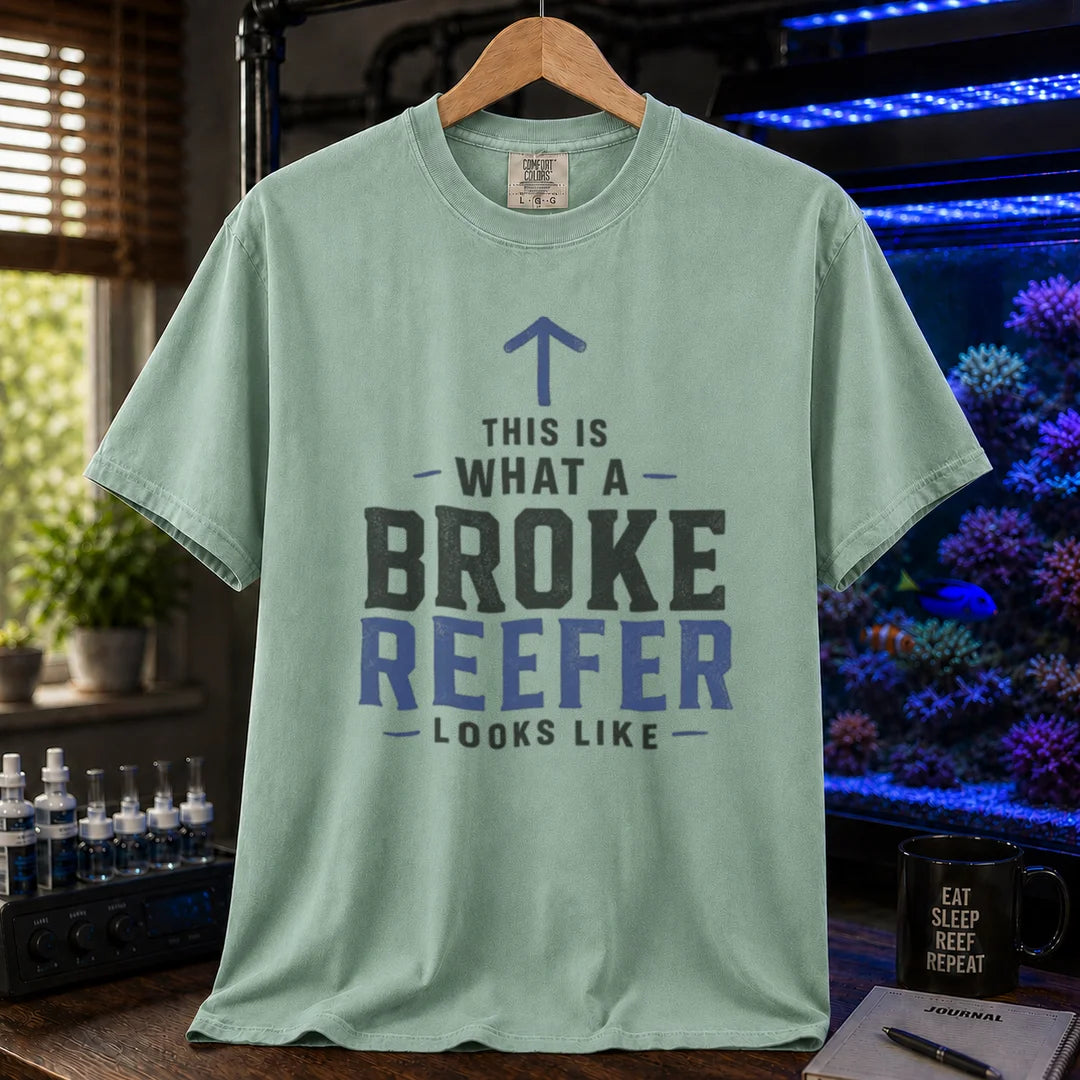Saltwater aquarium graphic t-shirt featuring an upward arrow and bold text: THIS IS WHAT A BROKE REEFER LOOKS LIKE, green crew neck tee