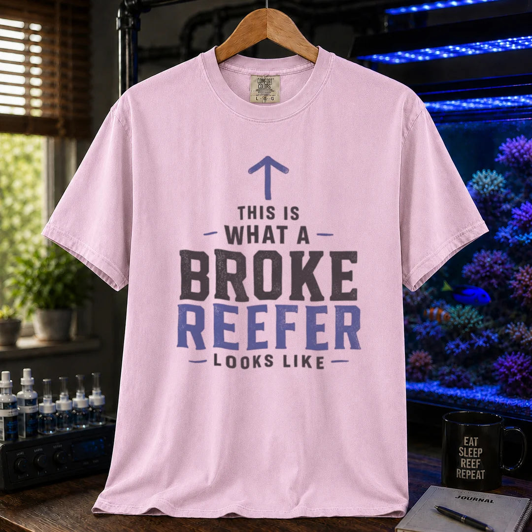 Saltwater aquarium graphic t-shirt featuring an upward arrow and bold text: THIS IS WHAT A BROKE REEFER LOOKS LIKE, pink crew neck tee