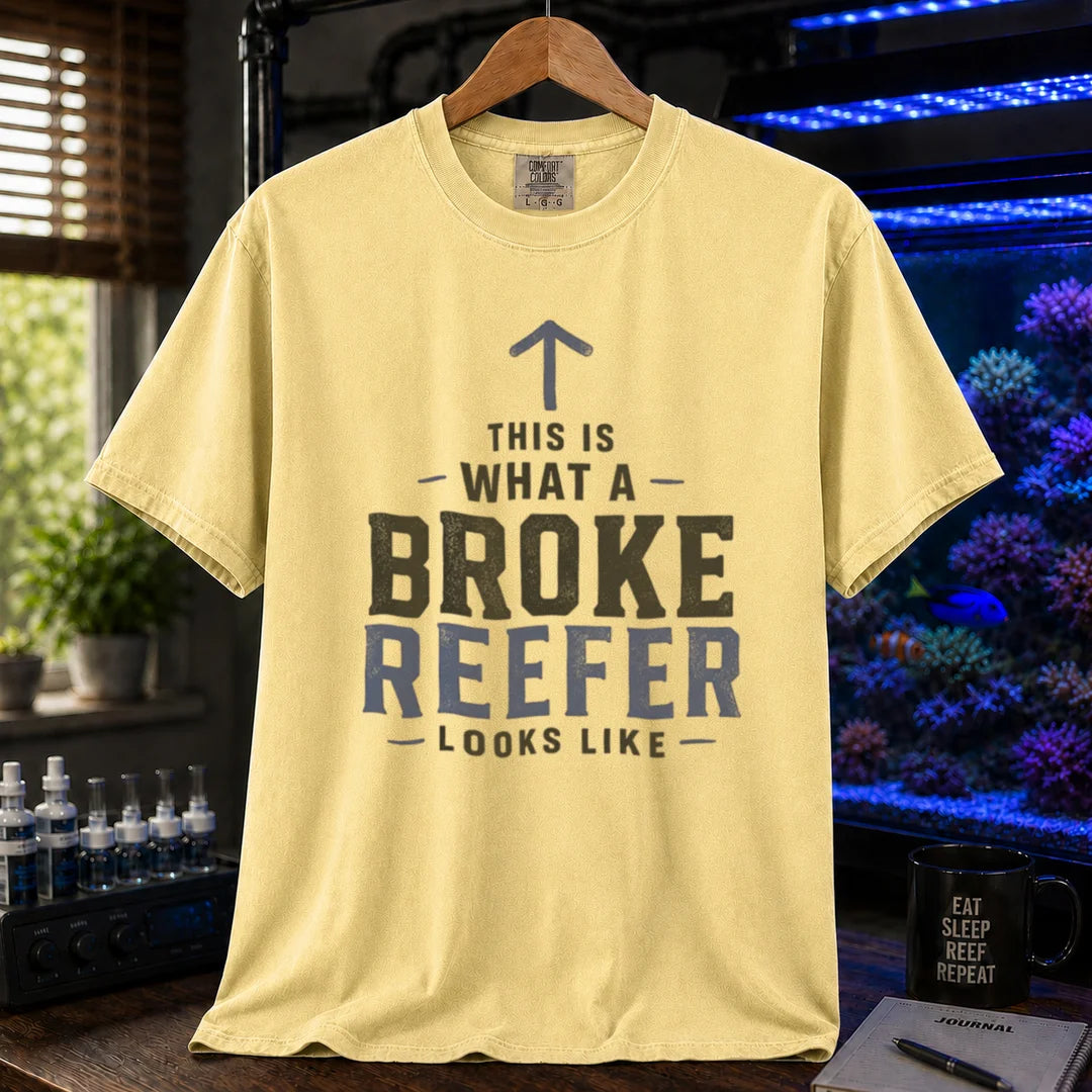 Saltwater aquarium graphic t-shirt featuring an upward arrow and bold text: THIS IS WHAT A BROKE REEFER LOOKS LIKE, yellow crew neck tee