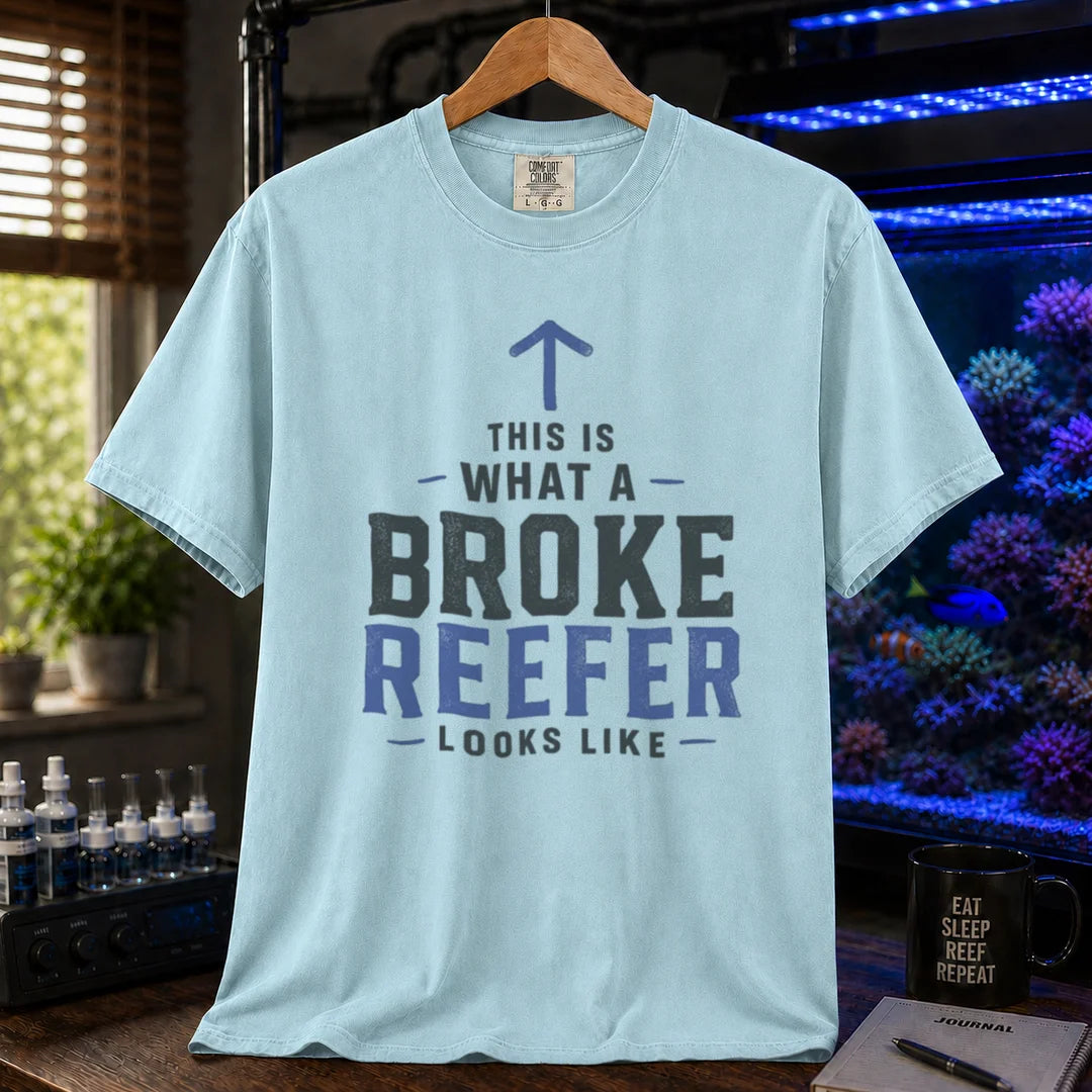Saltwater aquarium graphic t-shirt featuring an upward arrow and bold text: THIS IS WHAT A BROKE REEFER LOOKS LIKE, light blue crew neck tee