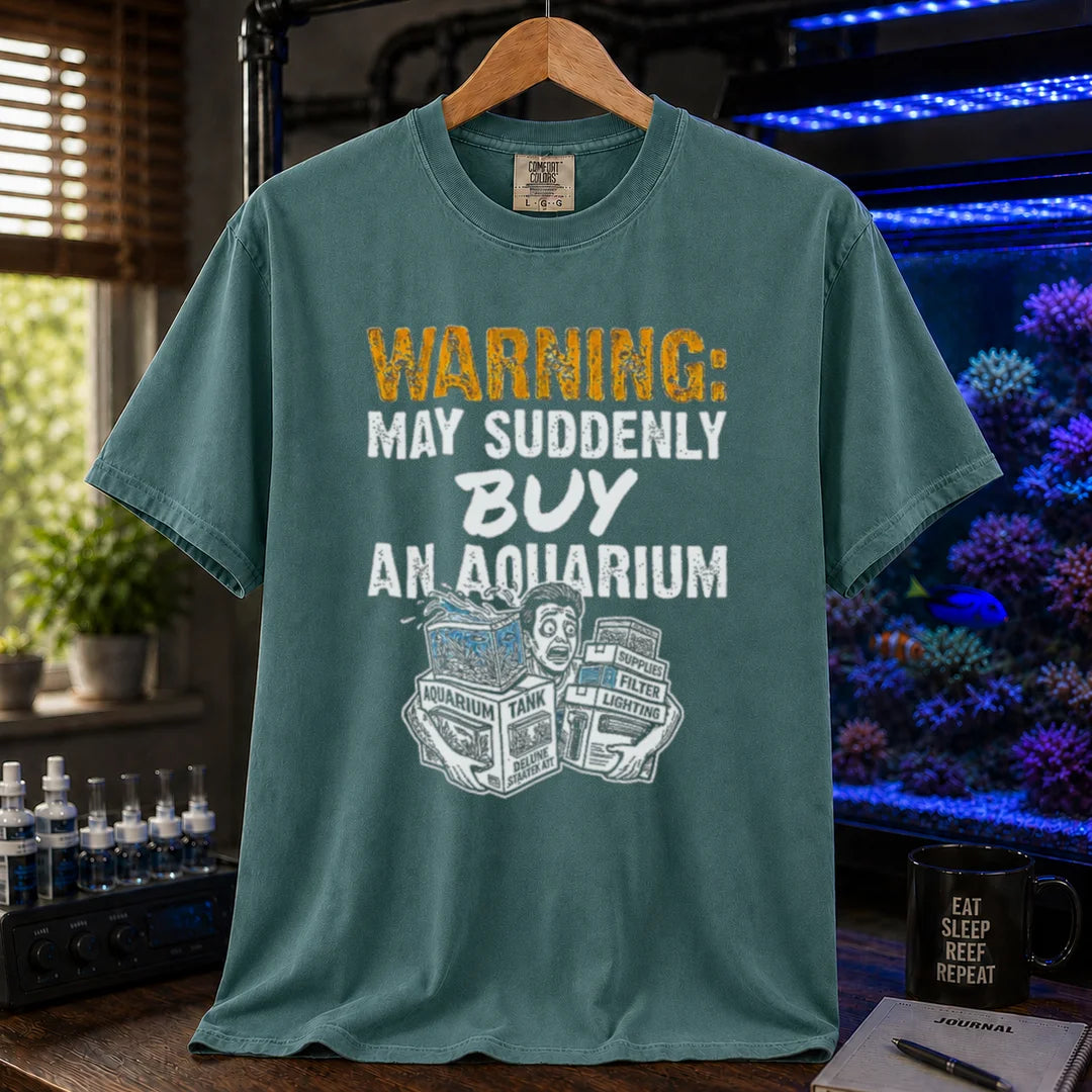 Saltwater aquarium graphic t-shirt featuring an illustration of a panicked person with tank boxes and text: WARNING: MAY SUDDENLY BUY AN AQUARIUM, green crew neck tee