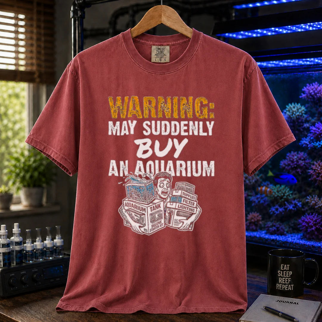 Saltwater aquarium graphic t-shirt featuring an illustration of a panicked person with tank boxes and text: WARNING: MAY SUDDENLY BUY AN AQUARIUM, maroon, red crew neck tee
