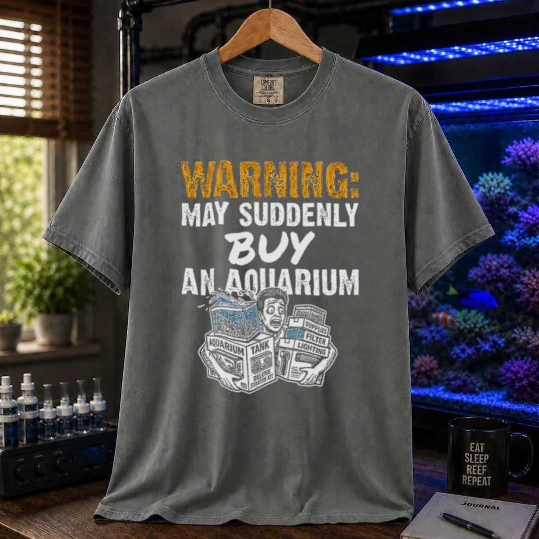 Saltwater aquarium graphic t-shirt featuring an illustration of a panicked person with tank boxes and text: WARNING: MAY SUDDENLY BUY AN AQUARIUM, dark grey crew neck tee