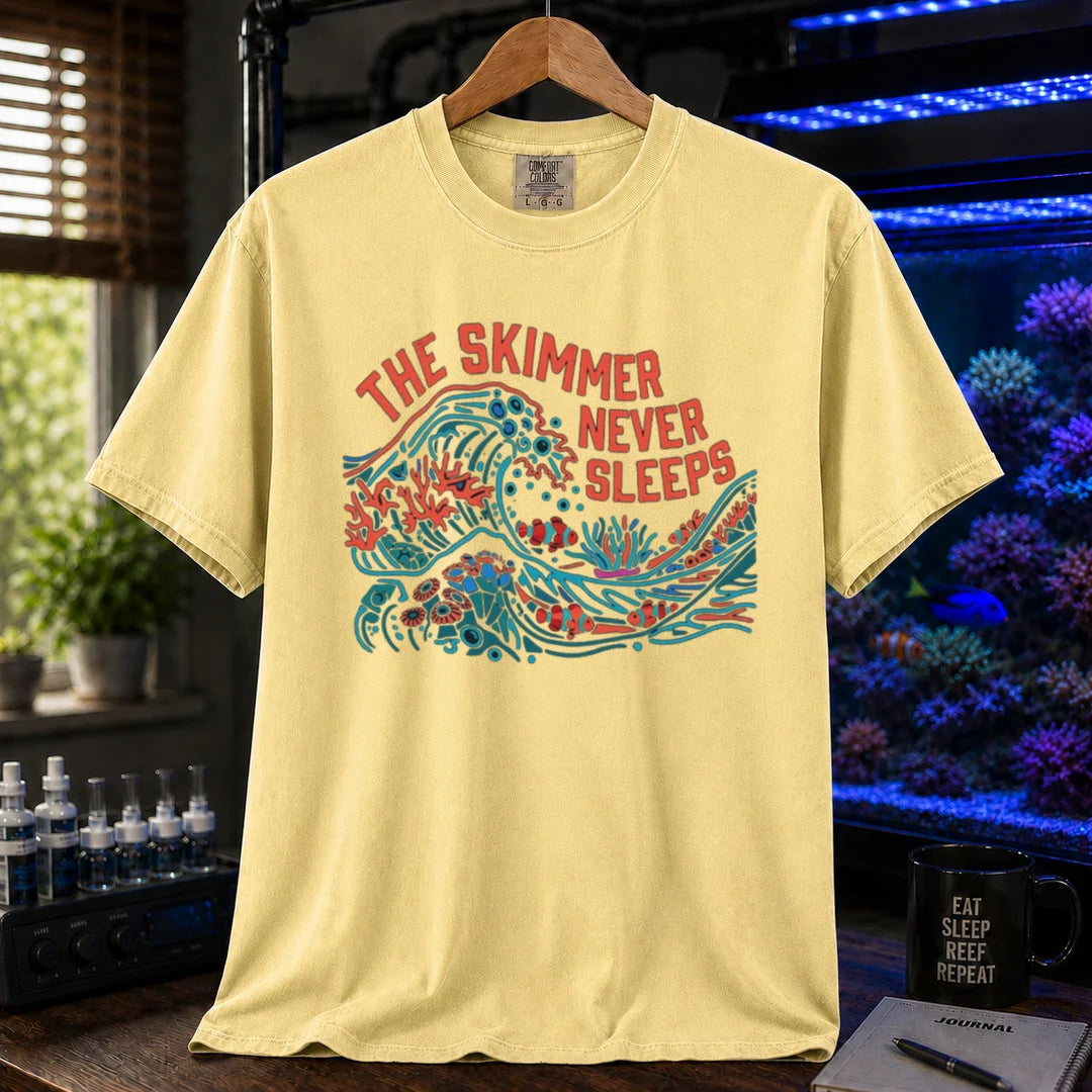 Saltwater aquarium graphic t-shirt featuring a colorful wave and reef illustration with text: THE SKIMMER NEVER SLEEPS, yellow crew neck tee