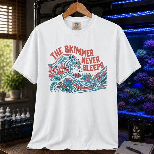 Saltwater aquarium graphic t-shirt featuring a colorful wave and reef illustration with text: THE SKIMMER NEVER SLEEPS, white crew neck tee