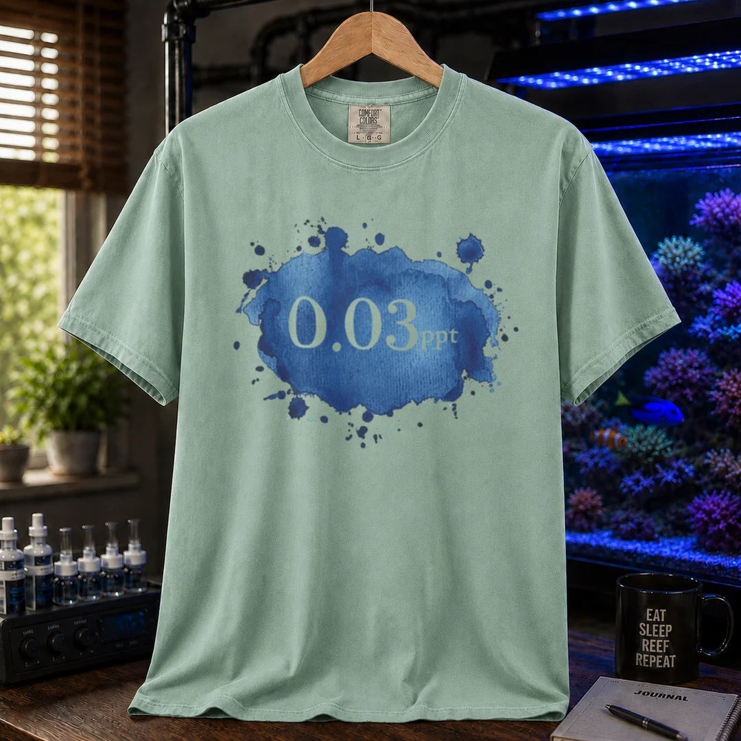 Saltwater aquarium graphic t-shirt featuring a blue watercolor splatter design and text: 0.03 ppt, green crew neck tee