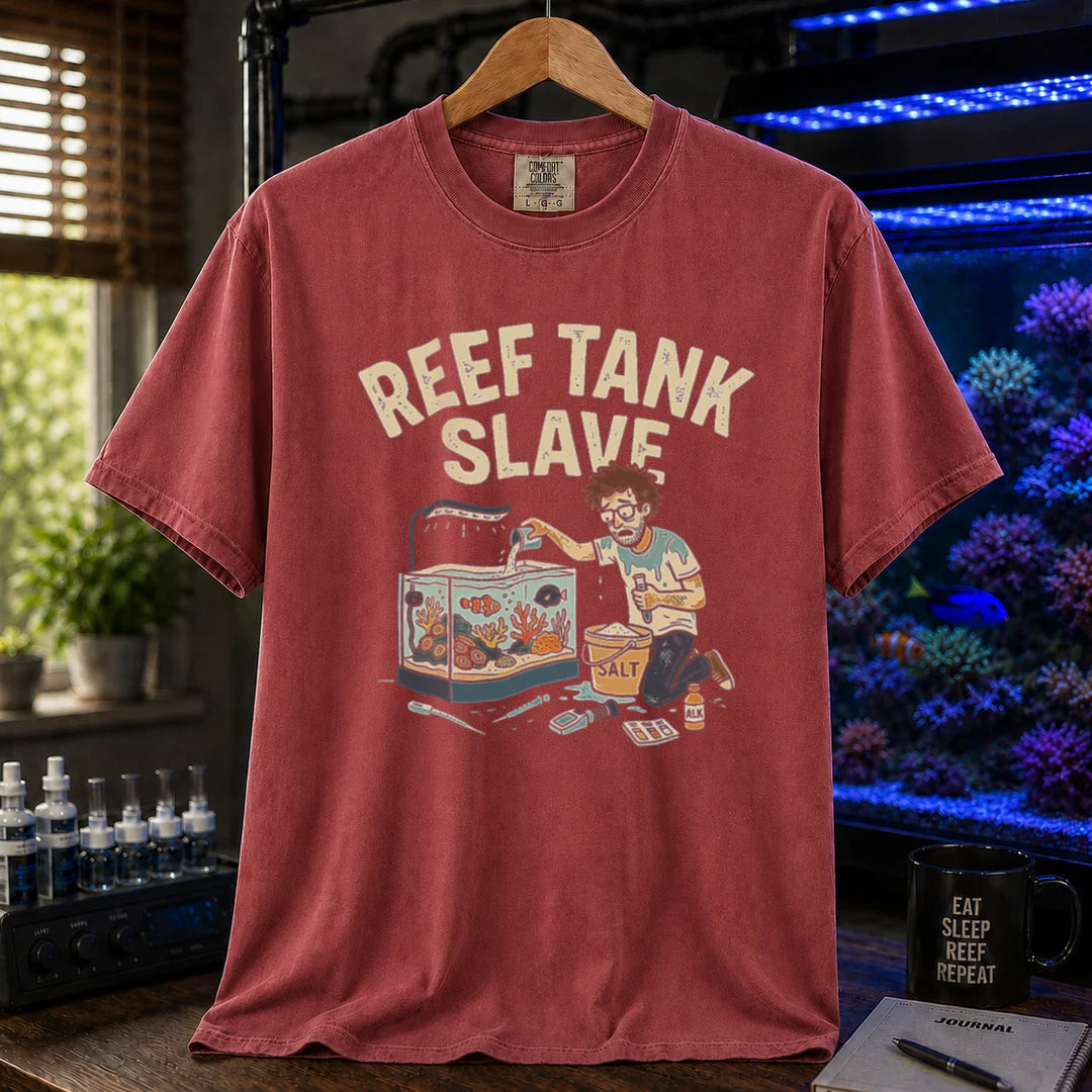 Saltwater aquarium graphic t-shirt featuring an aquarist maintaining a tank with a bucket of salt and text: REEF TANK SLAVE, maroon, red crew neck tee