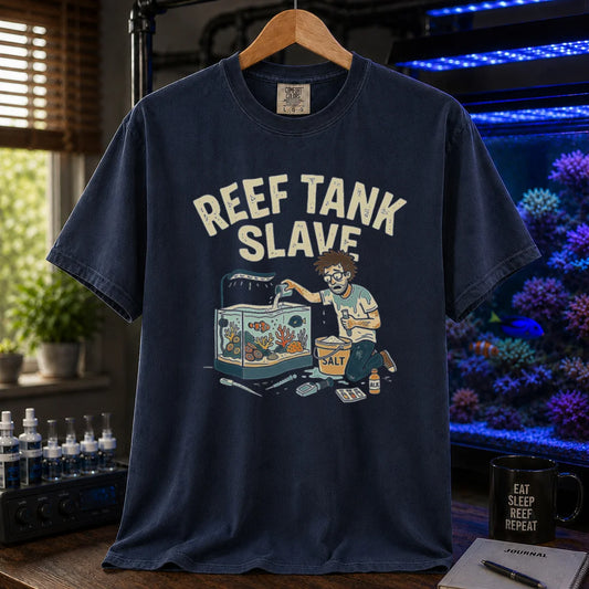 Saltwater aquarium graphic t-shirt featuring an aquarist maintaining a tank with a bucket of salt and text: REEF TANK SLAVE, navy crew neck tee