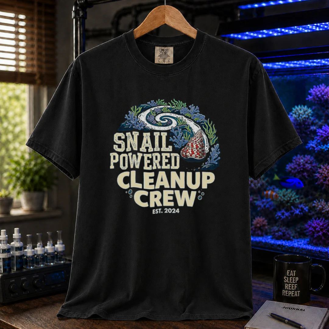 Saltwater aquarium graphic t-shirt featuring a snail leaving a clean trail through a reef with text: SNAIL POWERED CLEANUP CREW EST. 2024, black crew neck tee
