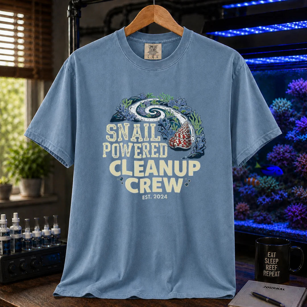 Saltwater aquarium graphic t-shirt featuring a snail leaving a clean trail through a reef with text: SNAIL POWERED CLEANUP CREW EST. 2024, blue crew neck tee