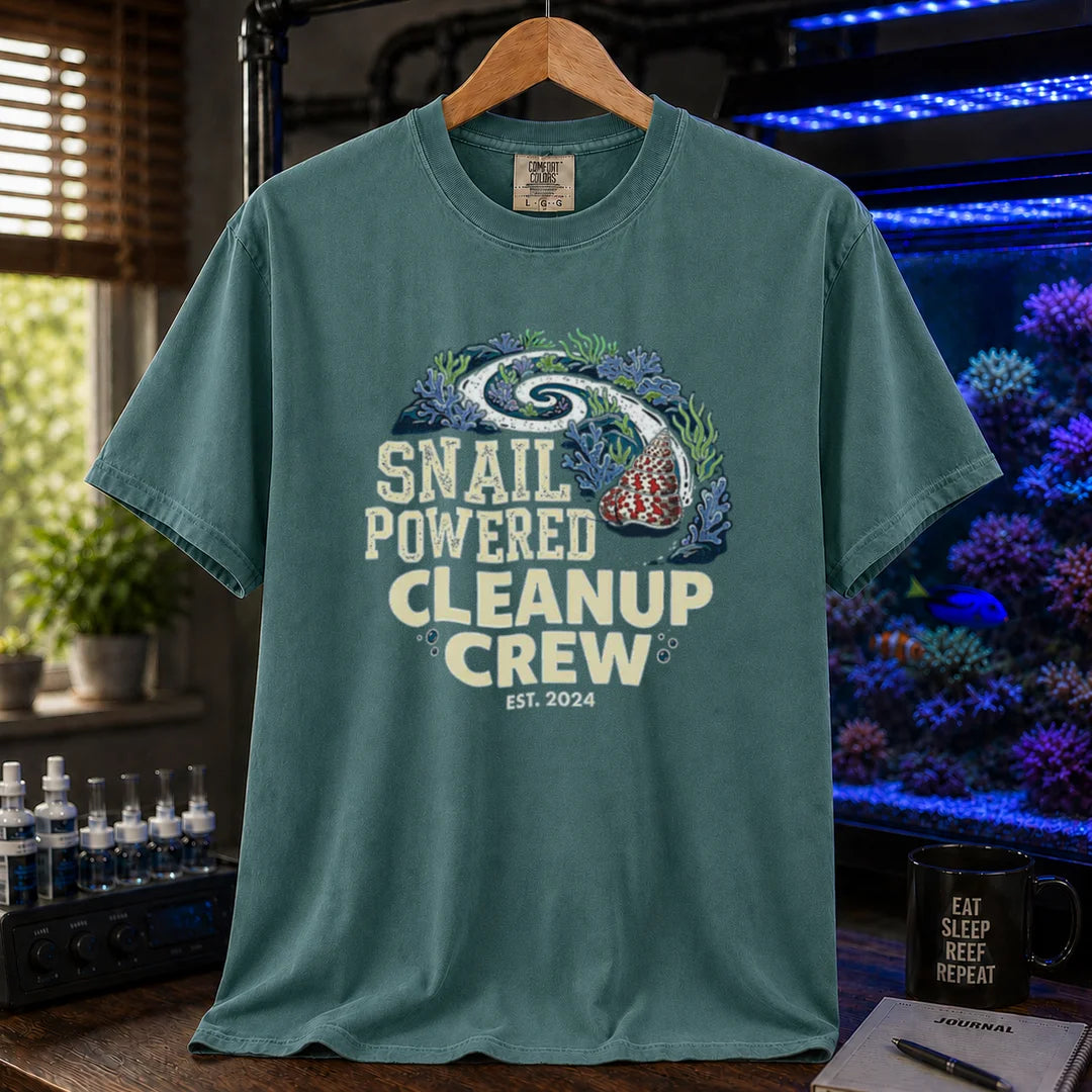 Saltwater aquarium graphic t-shirt featuring a snail leaving a clean trail through a reef with text: SNAIL POWERED CLEANUP CREW EST. 2024, green crew neck tee
