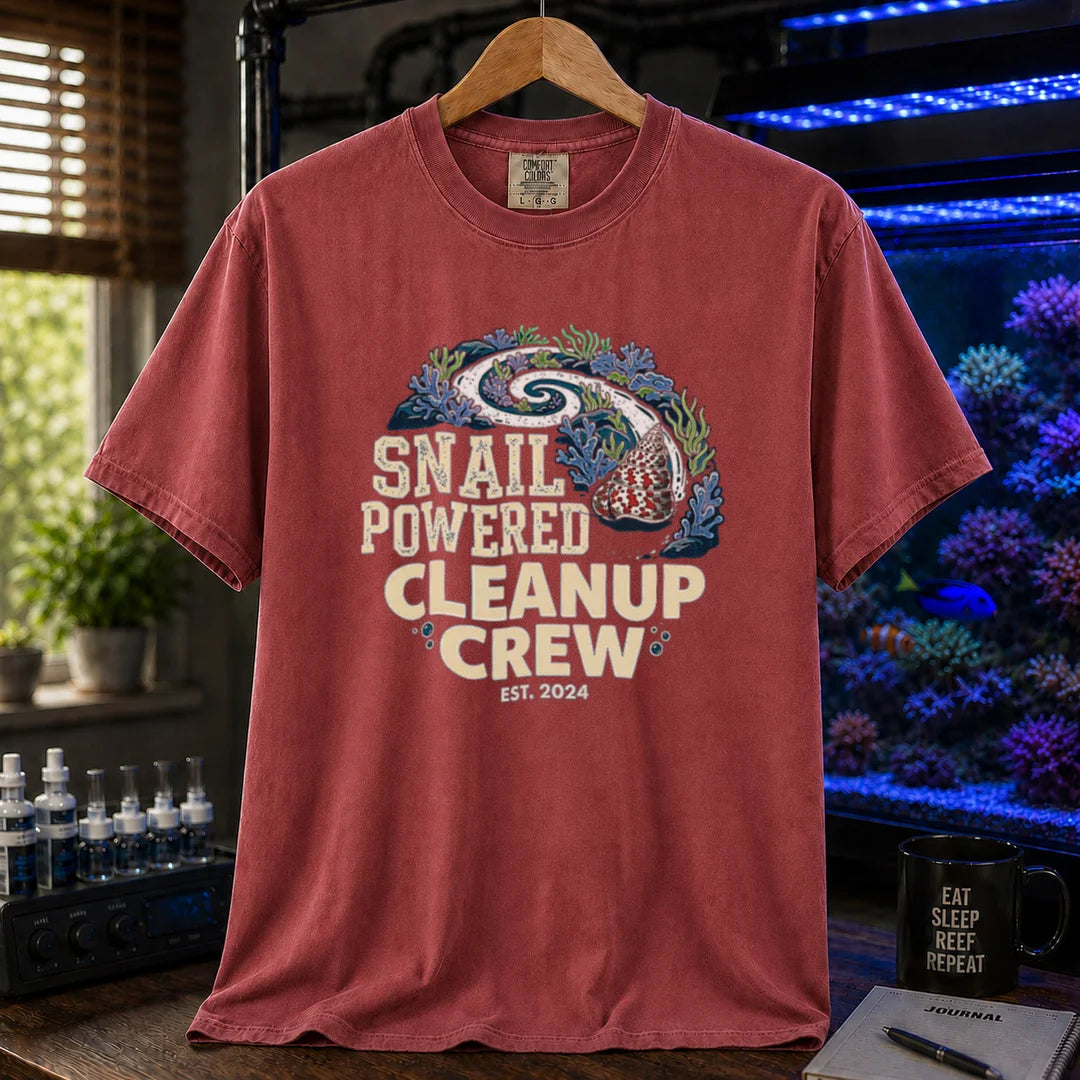 Saltwater aquarium graphic t-shirt featuring a snail leaving a clean trail through a reef with text: SNAIL POWERED CLEANUP CREW EST. 2024, maroon, red crew neck tee
