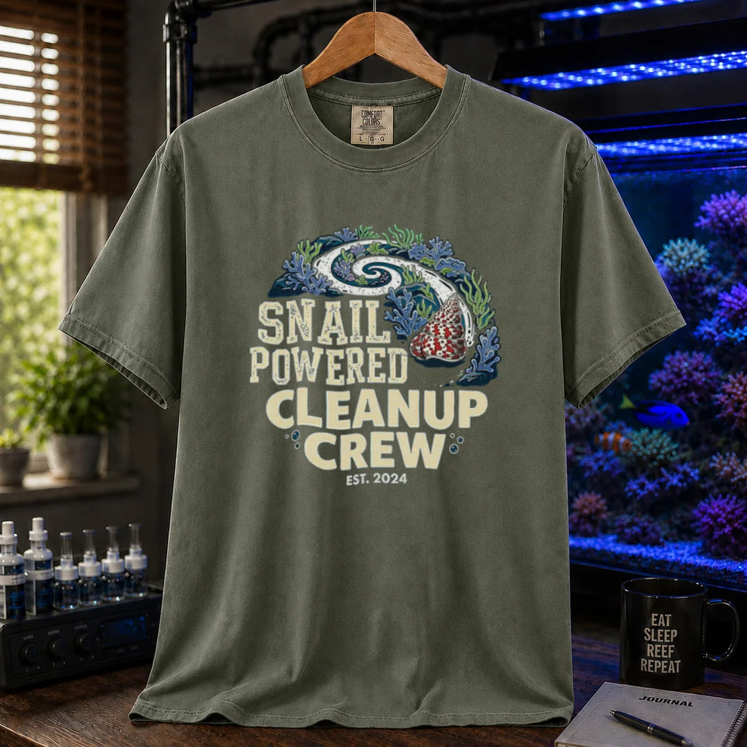Saltwater aquarium graphic t-shirt featuring a snail leaving a clean trail through a reef with text: SNAIL POWERED CLEANUP CREW EST. 2024, military green crew neck tee