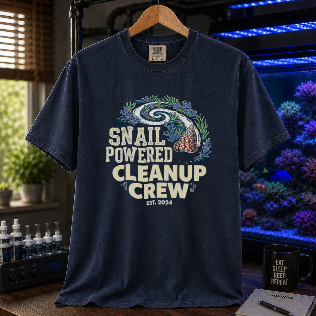 Saltwater aquarium graphic t-shirt featuring a snail leaving a clean trail through a reef with text: SNAIL POWERED CLEANUP CREW EST. 2024, navy crew neck tee