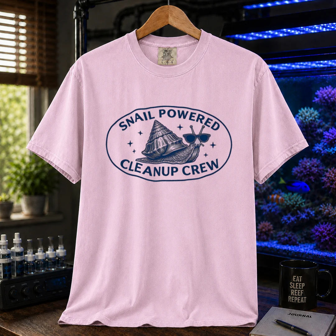 Saltwater aquarium graphic t-shirt featuring an oval emblem of a snail in sunglasses and text: SNAIL POWERED CLEANUP CREW, pink crew neck tee