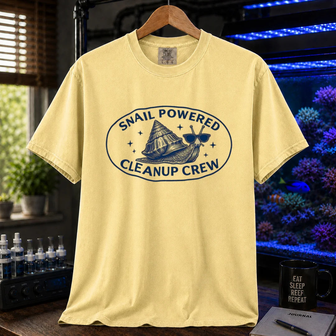 Saltwater aquarium graphic t-shirt featuring an oval emblem of a snail in sunglasses and text: SNAIL POWERED CLEANUP CREW, yellow crew neck tee