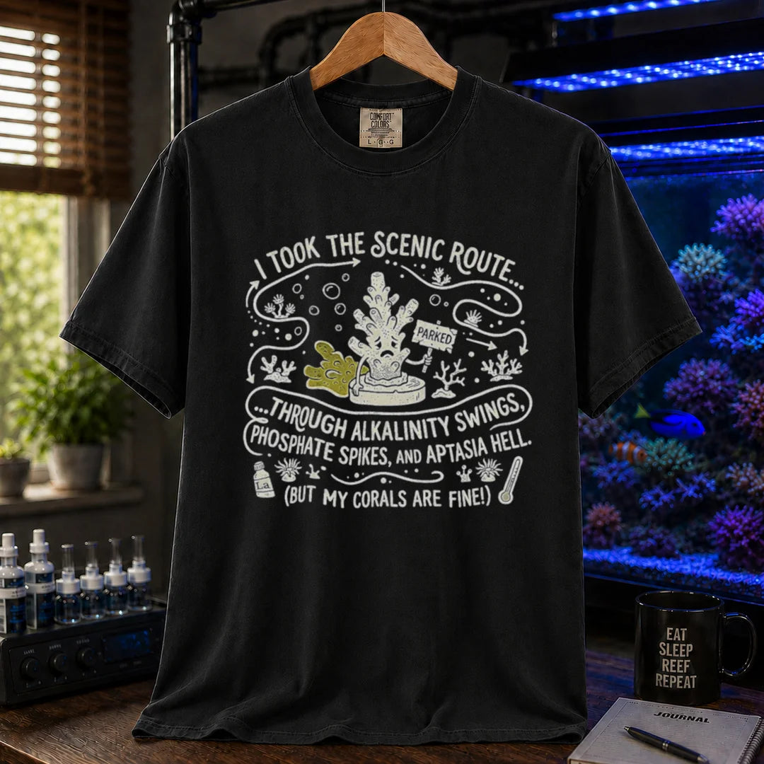 Saltwater aquarium graphic t-shirt featuring an illustrative map design with a coral character and text: I TOOK THE SCENIC ROUTE... THROUGH ALKALINITY SWINGS, PHOSPHATE SPIKES, AND APTASIA HELL. (BUT MY CORALS ARE FINE!), black crew neck tee