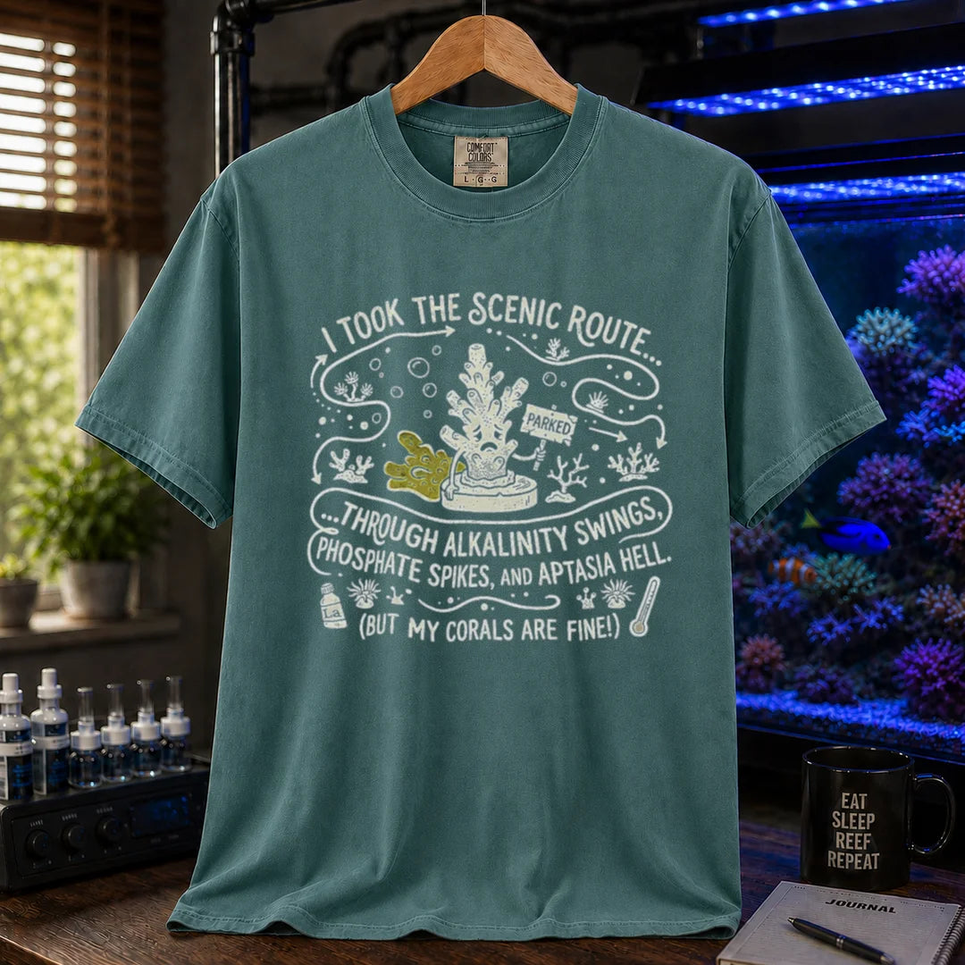Saltwater aquarium graphic t-shirt featuring an illustrative map design with a coral character and text: I TOOK THE SCENIC ROUTE... THROUGH ALKALINITY SWINGS, PHOSPHATE SPIKES, AND APTASIA HELL. (BUT MY CORALS ARE FINE!), green crew neck tee