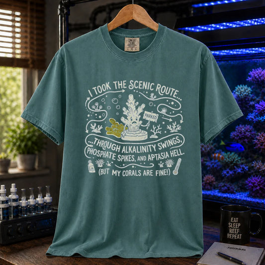 Saltwater aquarium graphic t-shirt featuring an illustrative map design with a coral character and text: I TOOK THE SCENIC ROUTE... THROUGH ALKALINITY SWINGS, PHOSPHATE SPIKES, AND APTASIA HELL. (BUT MY CORALS ARE FINE!), green crew neck tee