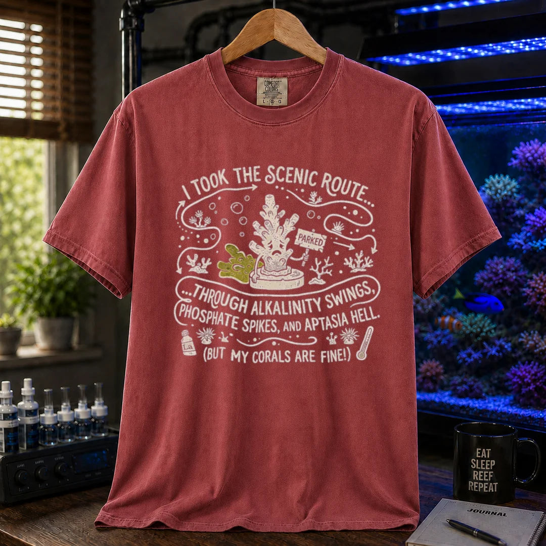Saltwater aquarium graphic t-shirt featuring an illustrative map design with a coral character and text: I TOOK THE SCENIC ROUTE... THROUGH ALKALINITY SWINGS, PHOSPHATE SPIKES, AND APTASIA HELL. (BUT MY CORALS ARE FINE!), maroon, red crew neck tee