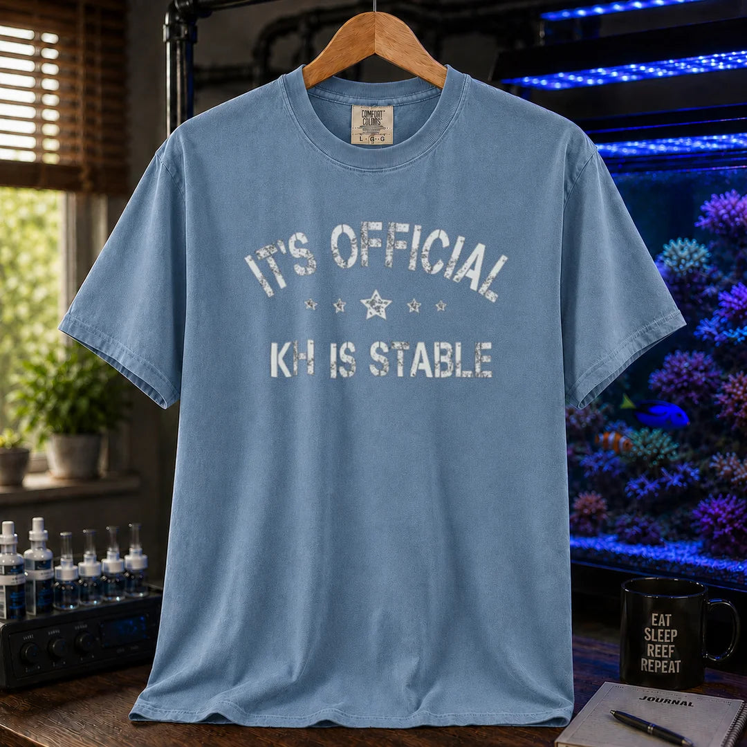 Saltwater aquarium graphic t-shirt featuring stars and distressed text: IT'S OFFICIAL KH IS STABLE, blue crew neck tee