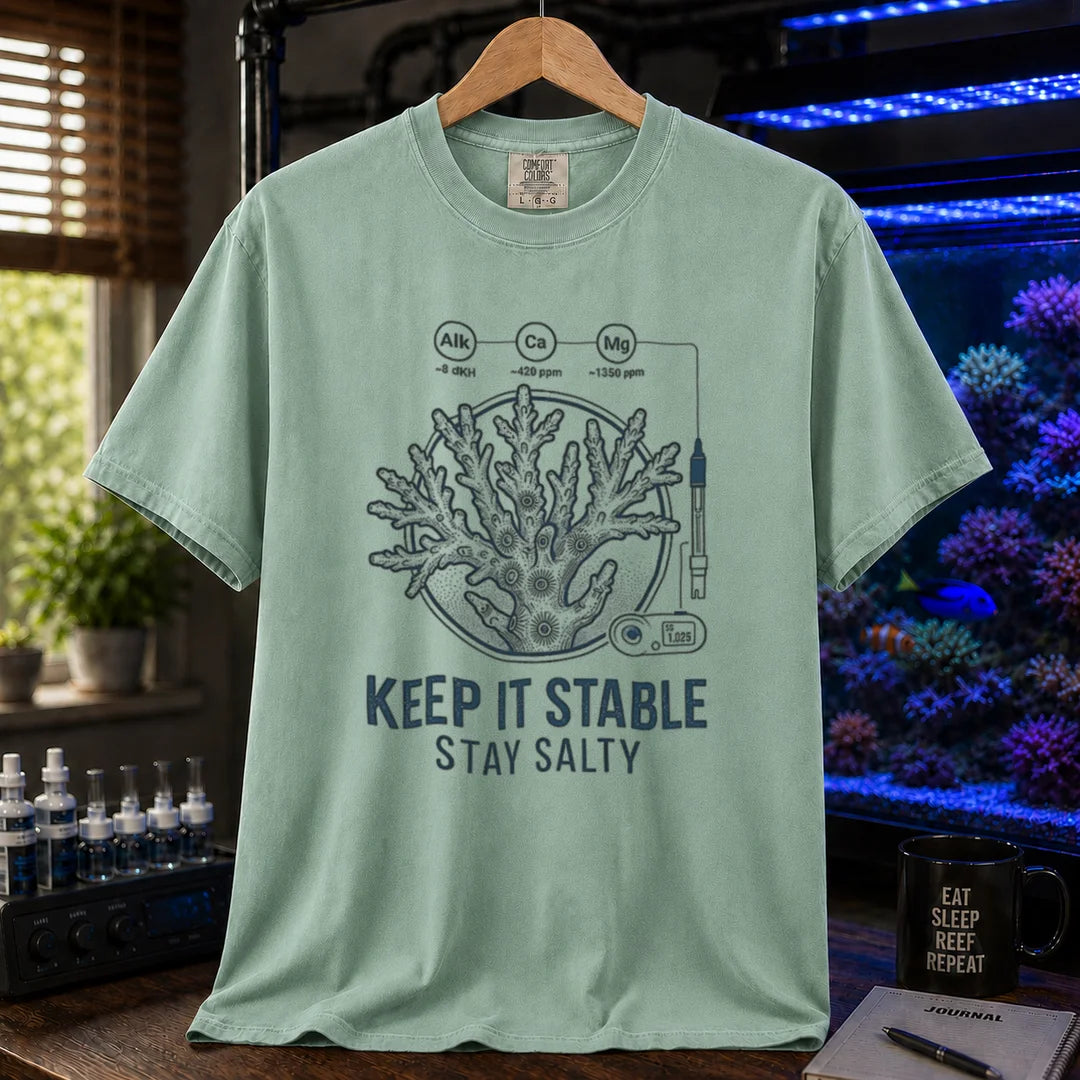 Saltwater aquarium graphic t-shirt featuring a coral illustration with chemical parameter nodes and text: KEEP IT STABLE STAY SALTY, green crew neck tee