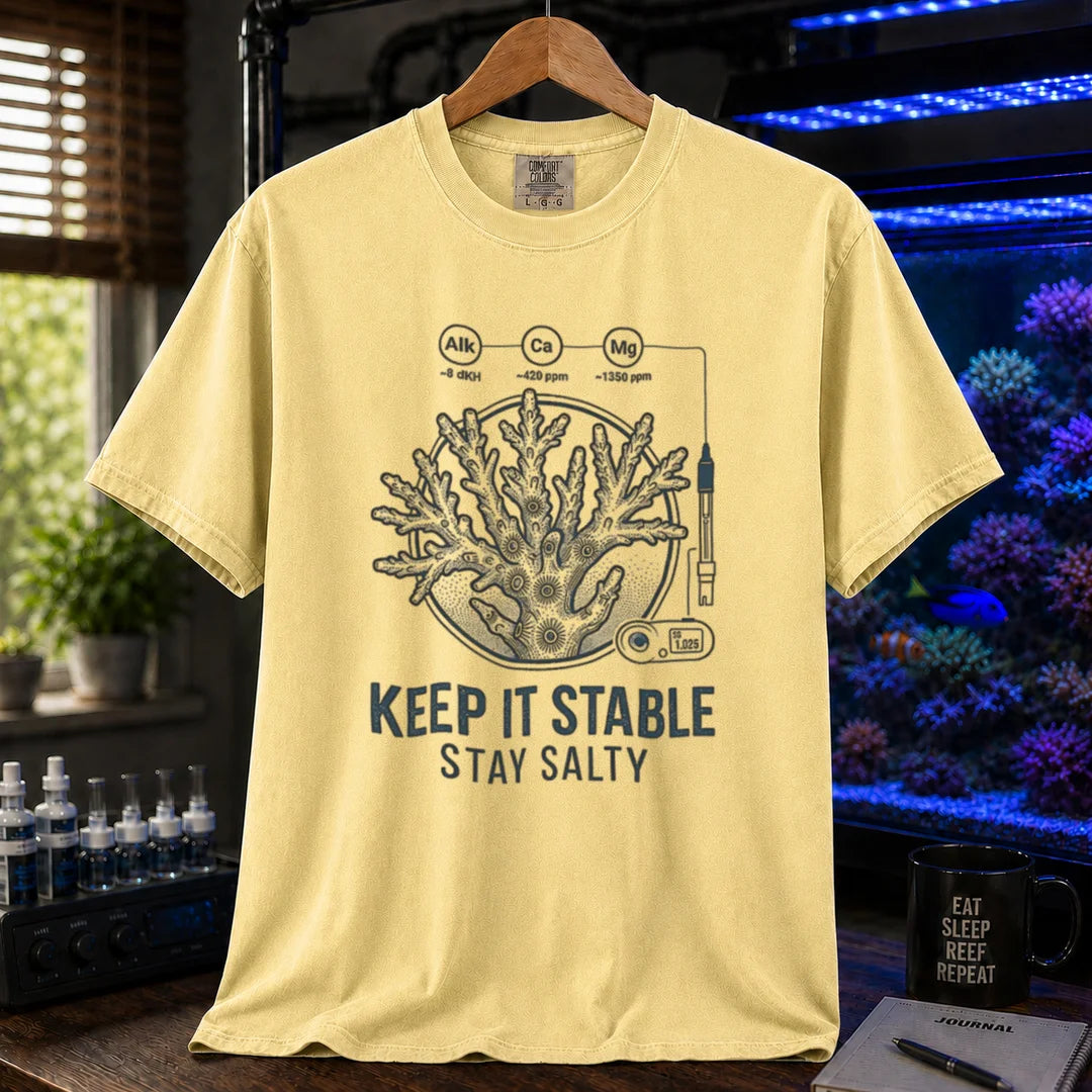 Saltwater aquarium graphic t-shirt featuring a coral illustration with chemical parameter nodes and text: KEEP IT STABLE STAY SALTY, yellow crew neck tee