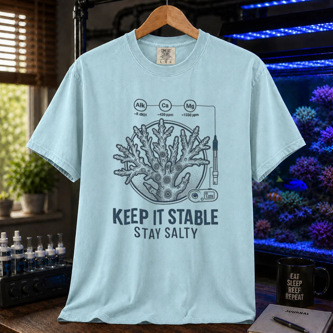 Saltwater aquarium graphic t-shirt featuring a coral illustration with chemical parameter nodes and text: KEEP IT STABLE STAY SALTY, light blue crew neck tee