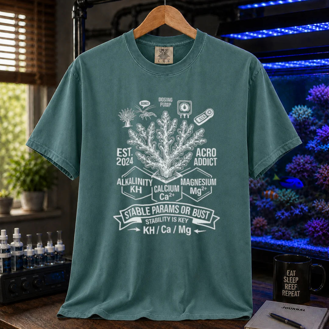 Saltwater aquarium graphic t-shirt featuring a coral center, parameter blocks, and text: STABLE PARAMS OR BUST STABILITY IS KEY KH / Ca / Mg, green crew neck tee