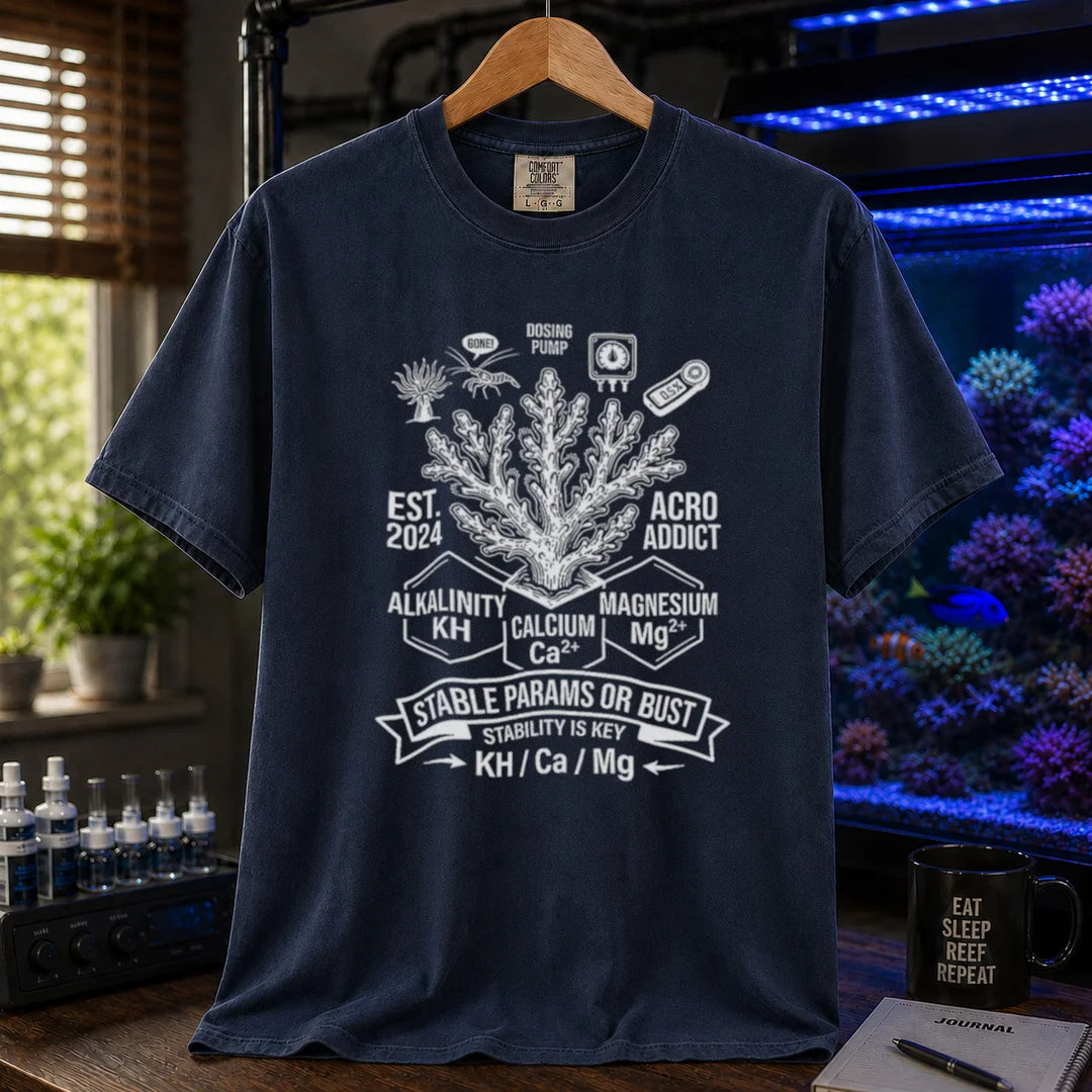 Saltwater aquarium graphic t-shirt featuring a coral center, parameter blocks, and text: STABLE PARAMS OR BUST STABILITY IS KEY KH / Ca / Mg, navy crew neck tee