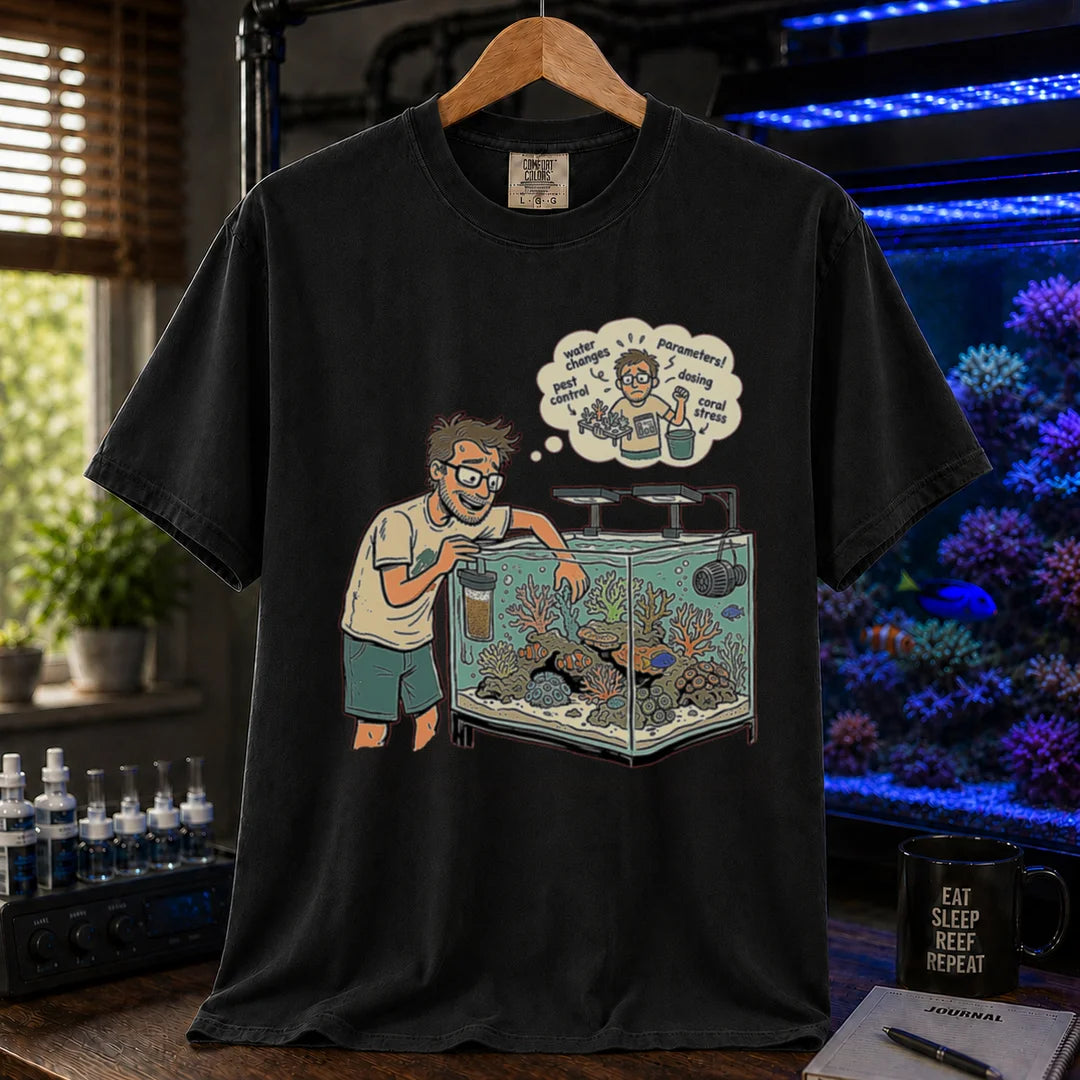 Saltwater aquarium graphic t-shirt featuring an aquarist maintaining a tank with a thought bubble of reef chores, black crew neck tee