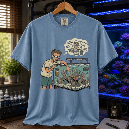 Saltwater aquarium graphic t-shirt featuring an aquarist maintaining a tank with a thought bubble of reef chores, blue crew neck tee
