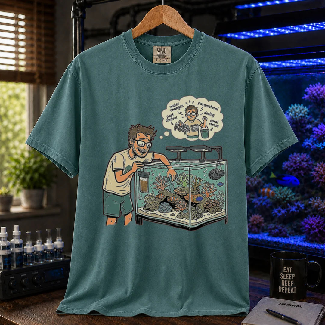 Saltwater aquarium graphic t-shirt featuring an aquarist maintaining a tank with a thought bubble of reef chores, green crew neck tee